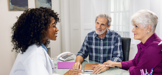 Barry, a Reblozyl patient, and his wife talking to a doctor